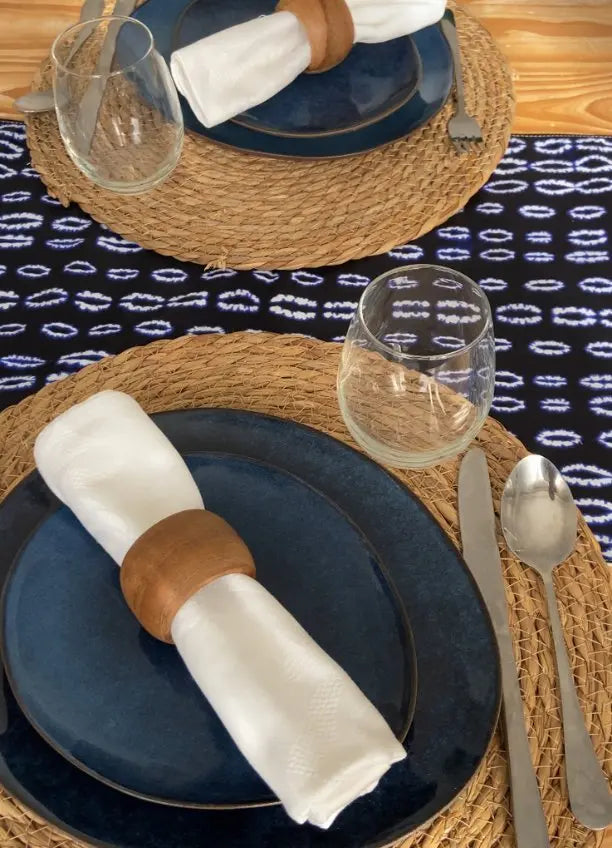 Chemin de table élégant de la collection TITA par Keur Nani, disposé sur une table en bois chaleureux. Son design raffiné et ses motifs délicats apportent une touche de sophistication et de charme à votre espace de repas, parfait pour recevoir avec style.